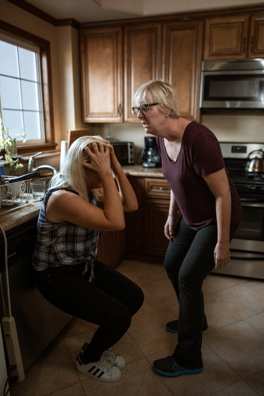 middle aged woman shouting at a fellow woman