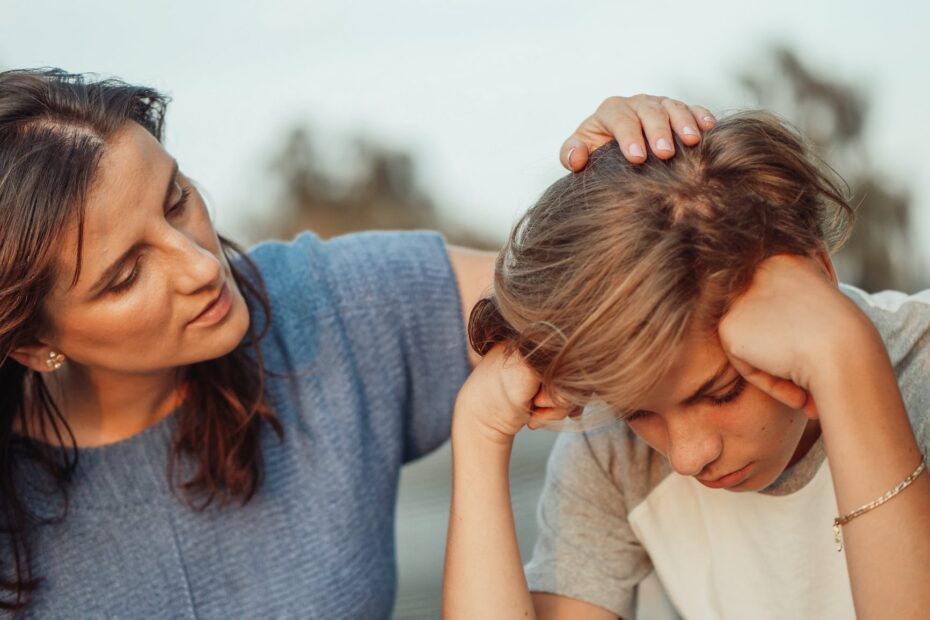 woman in blue shirt talking to a young man in white shirt