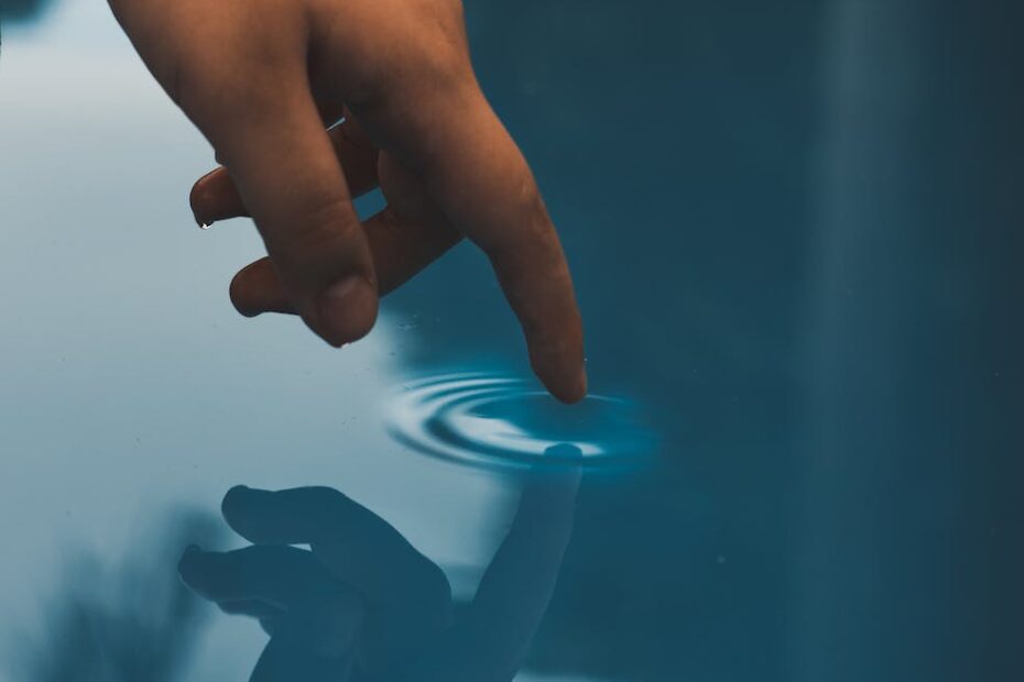 person touching pool of water
